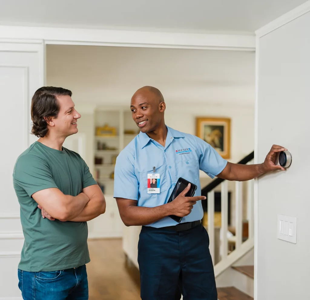 Residential HVAC technician inspecting a unit