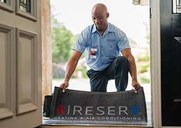 HVAC technician installing a new system at a West Orlando home