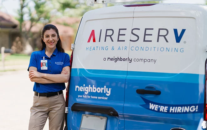 Technician performing scheduled maintenance on a commercial HVAC system